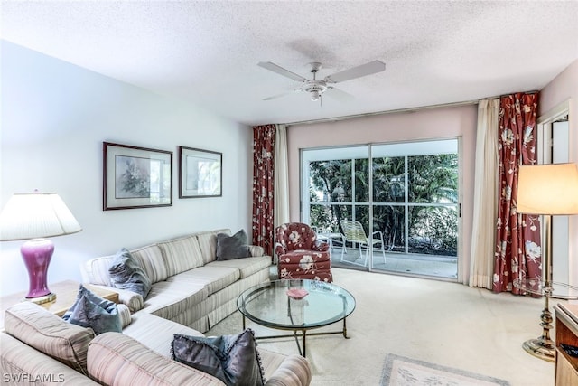 living room featuring carpet floors, a textured ceiling, and ceiling fan