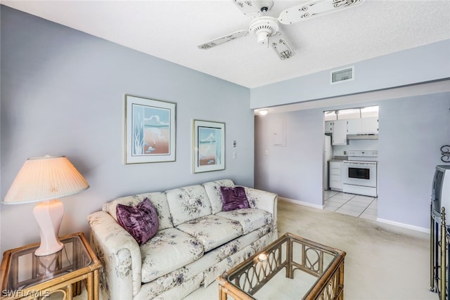 carpeted living room with a textured ceiling and ceiling fan