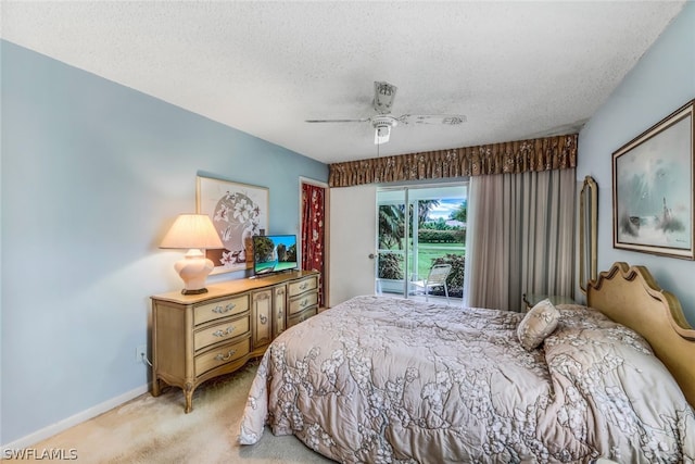 bedroom with a textured ceiling, carpet, access to exterior, and ceiling fan