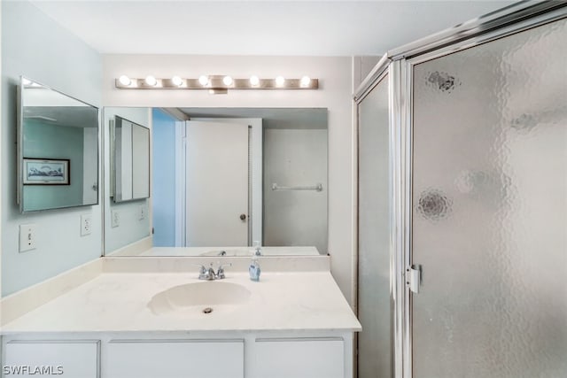 bathroom with vanity and a stall shower