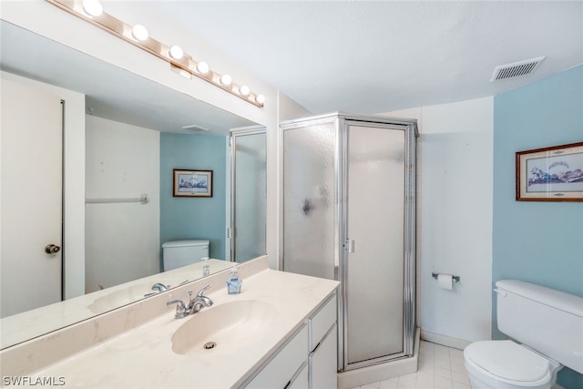 bathroom featuring vanity, walk in shower, toilet, and tile patterned floors