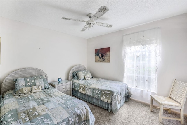 carpeted bedroom with a textured ceiling and ceiling fan
