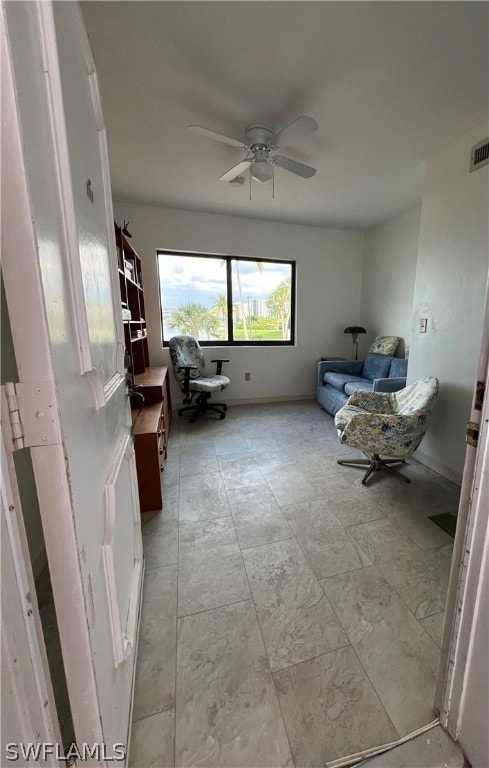 interior space with ceiling fan and light tile patterned floors