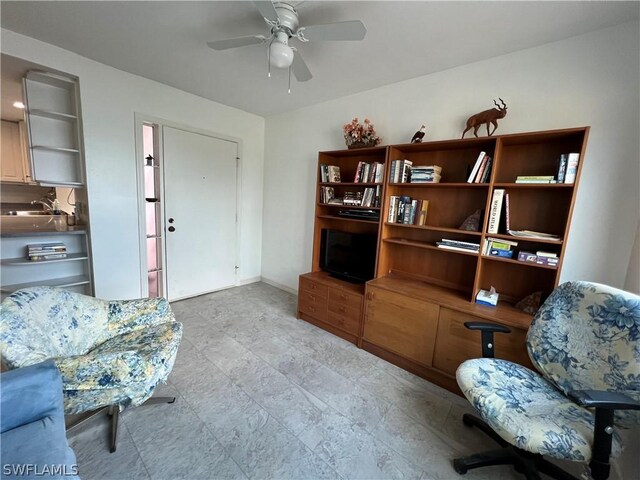 sitting room featuring sink, light tile patterned floors, and ceiling fan