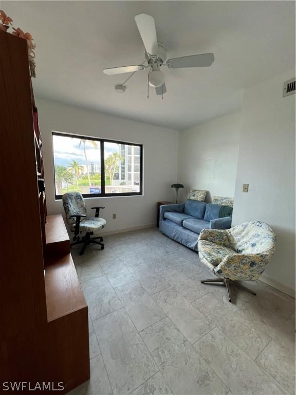 tiled living room with ceiling fan