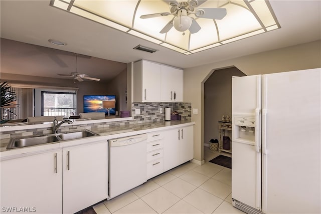 kitchen with white appliances, white cabinets, sink, decorative backsplash, and light tile patterned flooring