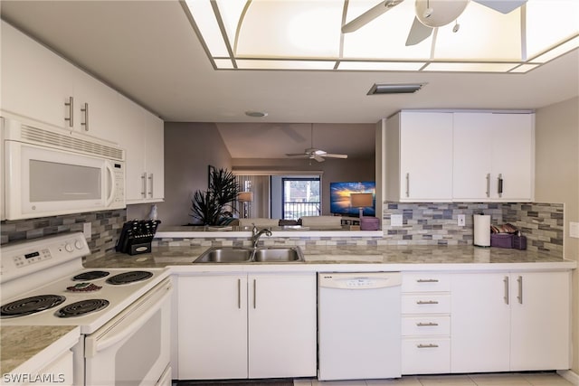 kitchen with white cabinets, white appliances, sink, and tasteful backsplash