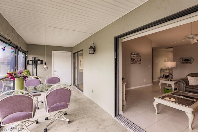 sunroom featuring ceiling fan