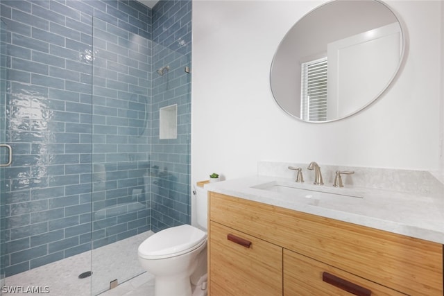 bathroom featuring vanity, toilet, and a shower