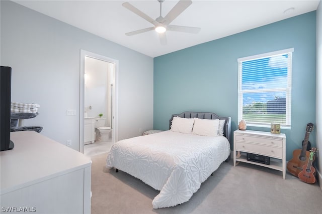 carpeted bedroom featuring ceiling fan and connected bathroom