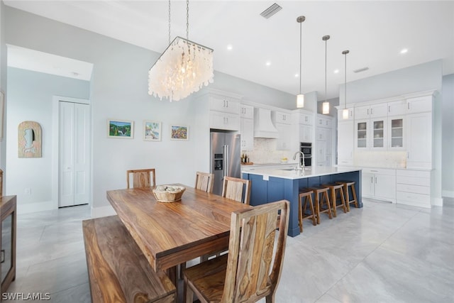 dining space with sink and an inviting chandelier