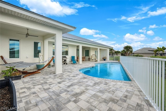 view of pool with area for grilling, ceiling fan, and a patio