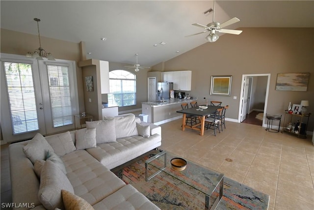 living room featuring ceiling fan, light tile patterned floors, and high vaulted ceiling