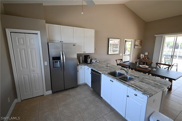 kitchen with sink, white cabinetry, light stone counters, stainless steel fridge with ice dispenser, and kitchen peninsula