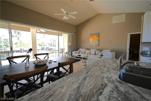 living room featuring sink, vaulted ceiling, and ceiling fan