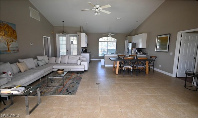 tiled living room with high vaulted ceiling and ceiling fan