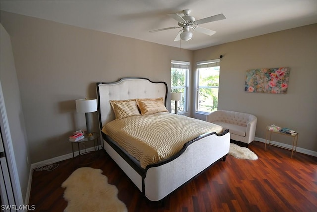 bedroom with dark hardwood / wood-style floors and ceiling fan