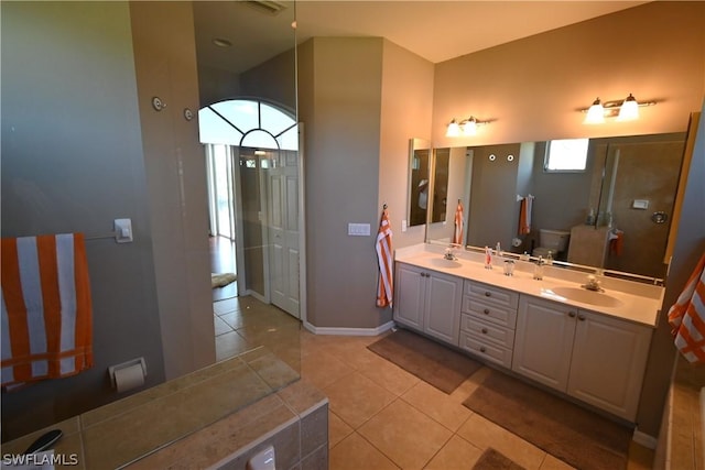 bathroom featuring vanity, tile patterned floors, and toilet