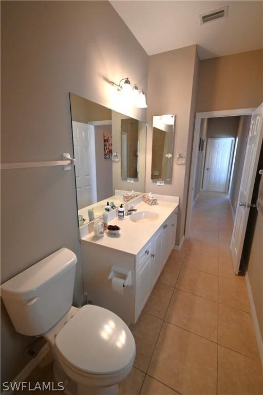 bathroom featuring tile patterned flooring, vanity, and toilet