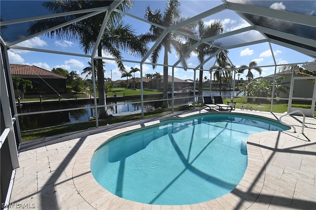 view of pool with glass enclosure, a water view, and a patio area