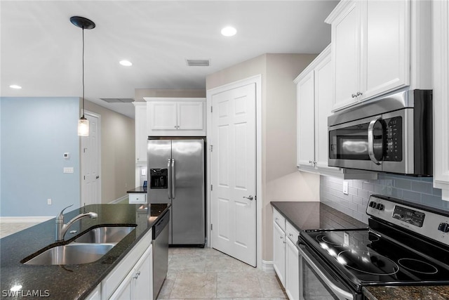 kitchen with sink, white cabinetry, tasteful backsplash, appliances with stainless steel finishes, and pendant lighting