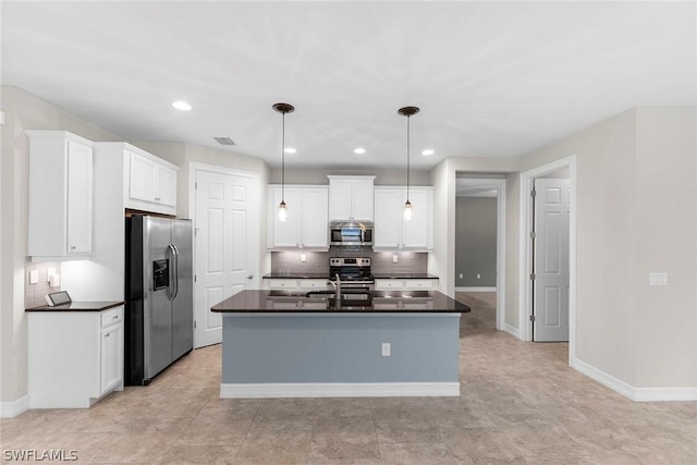 kitchen featuring sink, appliances with stainless steel finishes, white cabinetry, a center island with sink, and decorative light fixtures