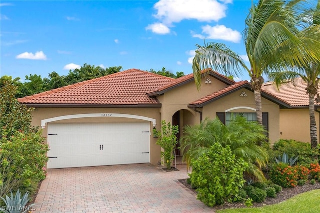 mediterranean / spanish-style house with a garage