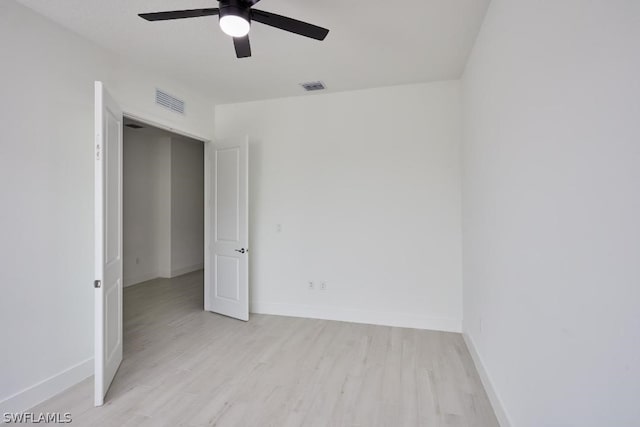 spare room featuring ceiling fan and light wood-type flooring