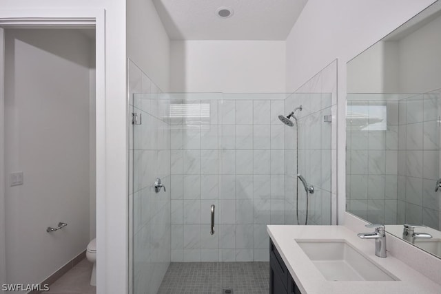 bathroom with tile patterned flooring, vanity, toilet, and a shower with door