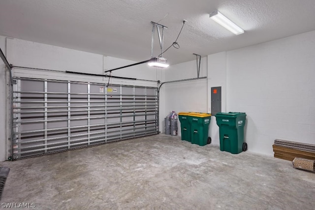 garage featuring electric panel and a garage door opener