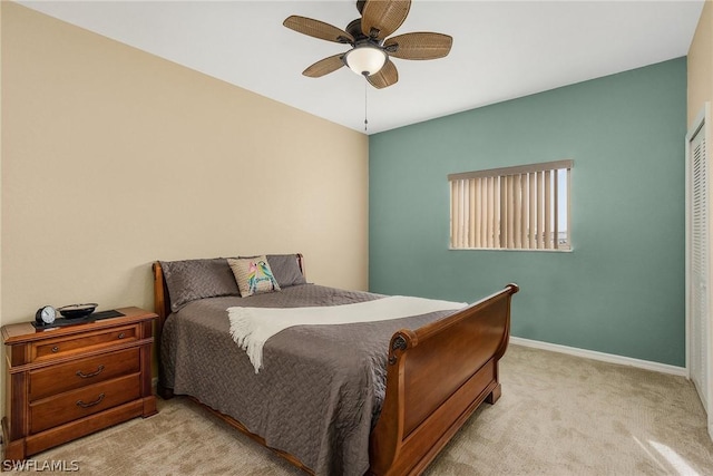 bedroom featuring ceiling fan, light colored carpet, and a closet