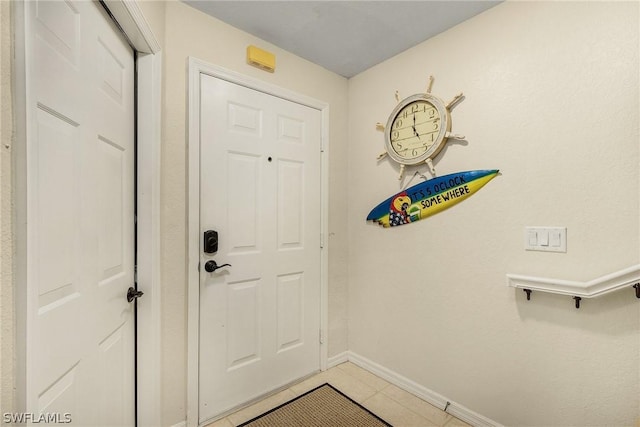 doorway to outside featuring tile patterned floors