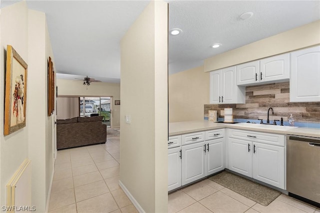 kitchen with dishwasher, light tile patterned floors, white cabinetry, and sink