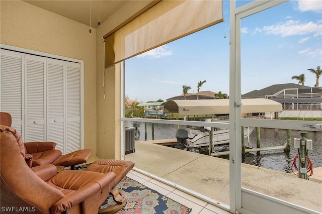 sunroom / solarium featuring a water view and plenty of natural light