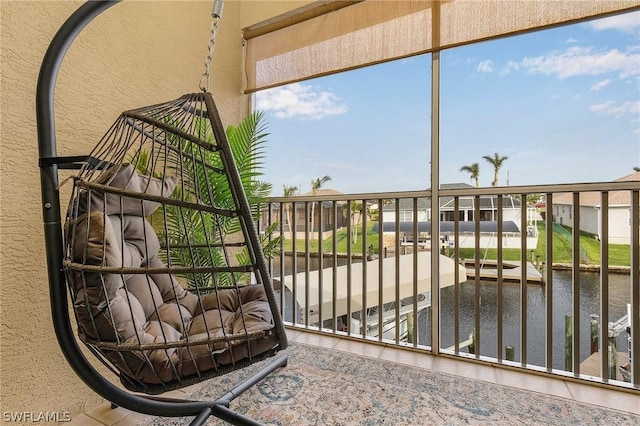 sunroom featuring a water view and plenty of natural light