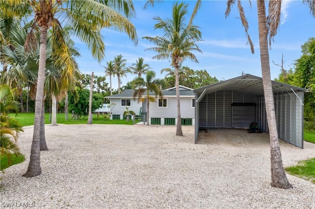 exterior space featuring a carport and gravel driveway