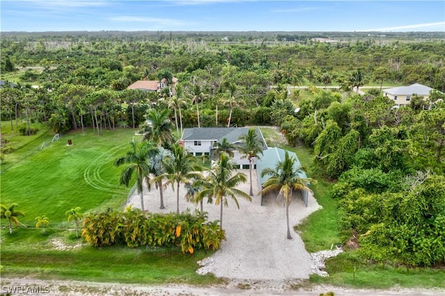 birds eye view of property featuring a wooded view