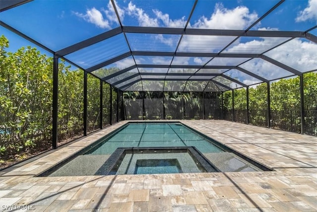 view of swimming pool with a lanai and an in ground hot tub