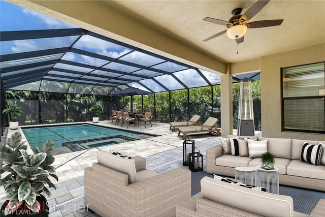 view of swimming pool featuring a lanai, ceiling fan, a patio area, and an outdoor hangout area