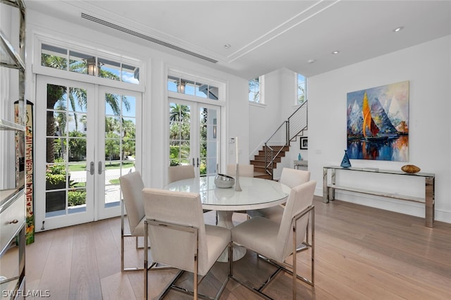 dining area featuring french doors and light wood-type flooring