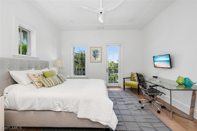 bedroom featuring wood-type flooring and access to exterior