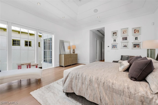 bedroom with crown molding, access to exterior, and hardwood / wood-style flooring