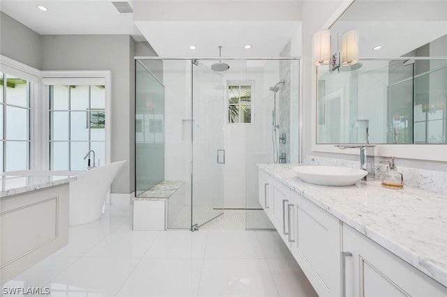 bathroom with tile patterned flooring, vanity, and independent shower and bath