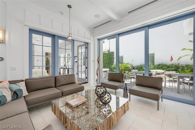 living room with beamed ceiling and french doors