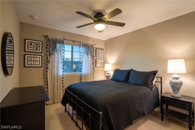 bedroom with ceiling fan and light colored carpet