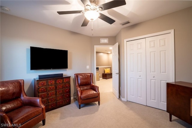 sitting room featuring light carpet and ceiling fan