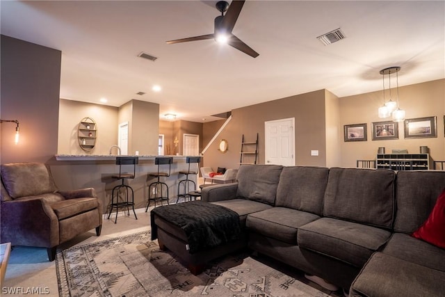 carpeted living room with ceiling fan