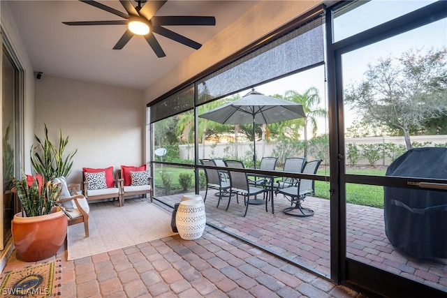 sunroom with ceiling fan and a healthy amount of sunlight