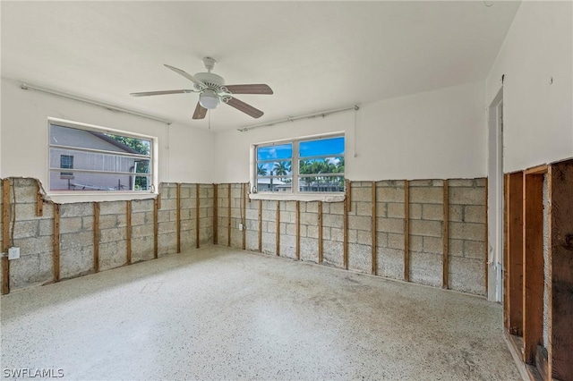 unfurnished room with ceiling fan