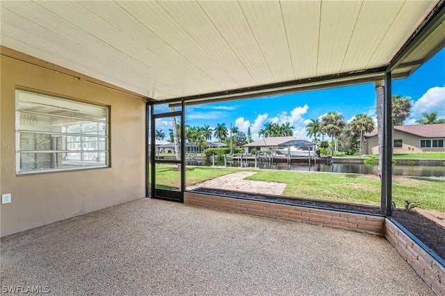 unfurnished sunroom with a water view